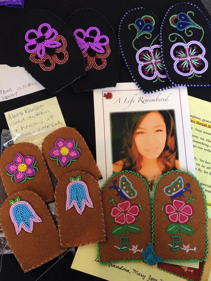 photograph of young Indigenous woman with beaded vamps on the table around her image